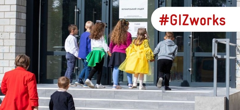 Children enter a reconstructed school in Ukraine.