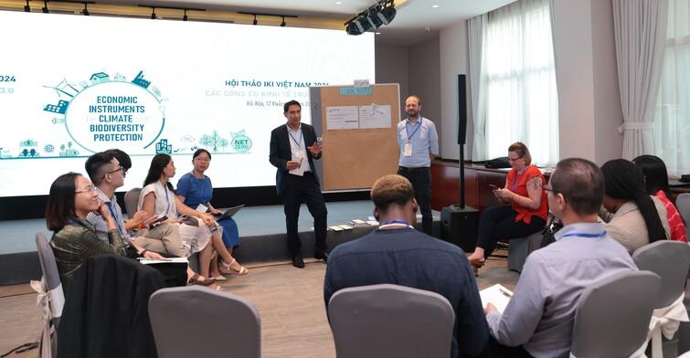 2 men doing a presentation in front of a group of people