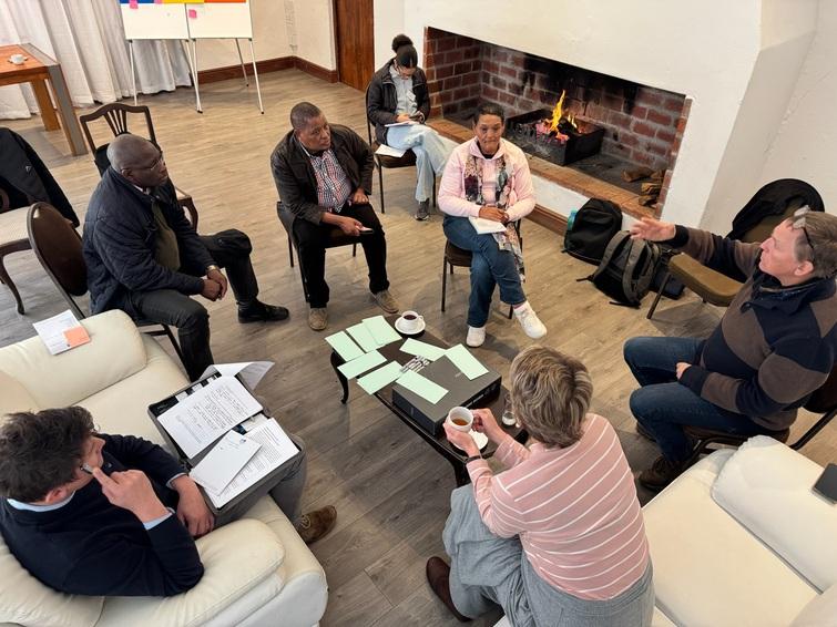 Group of people sitting in a circle discussing 