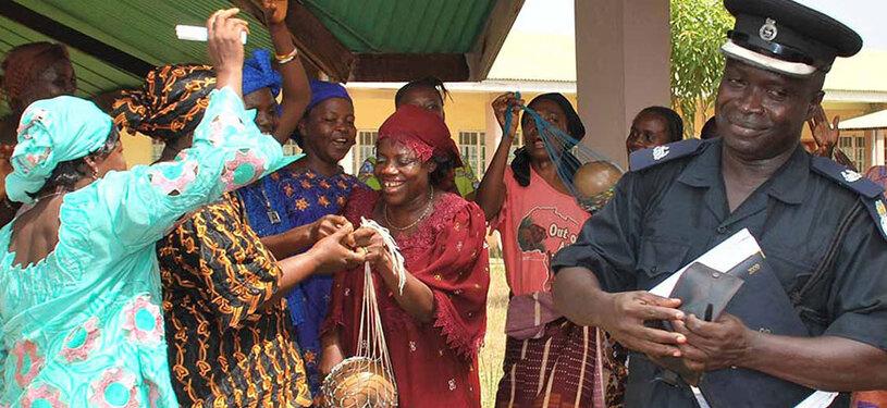 A police officer surrounded by a group of women