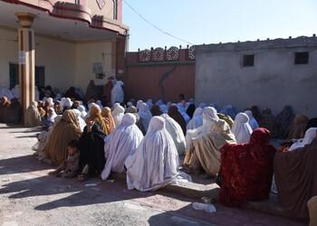 View of a courtyard with a large group of women sitting