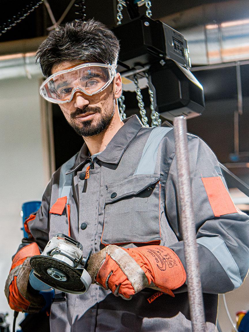 Worker with angle grinder