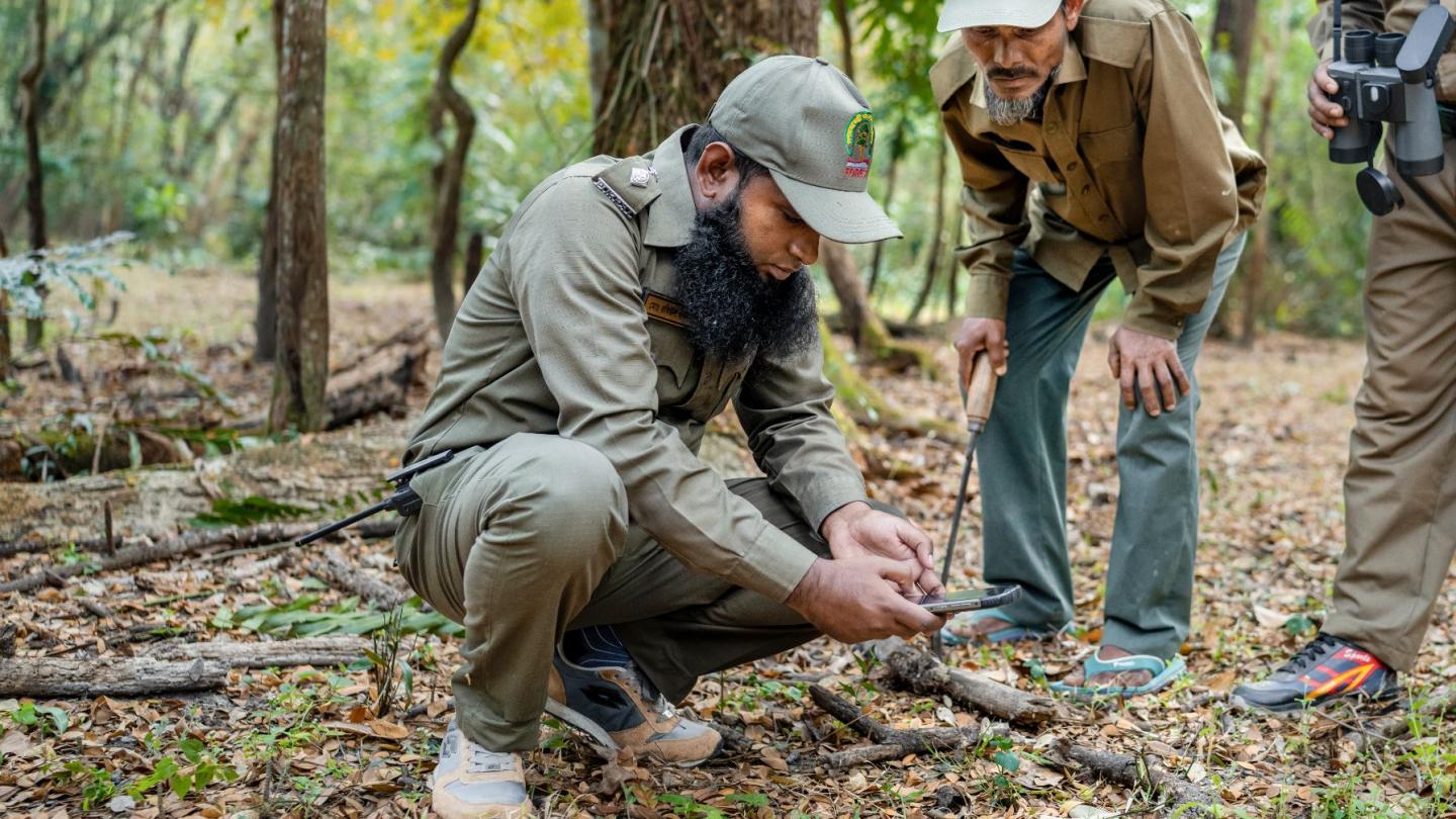 A ranger logs a find location using an app.
