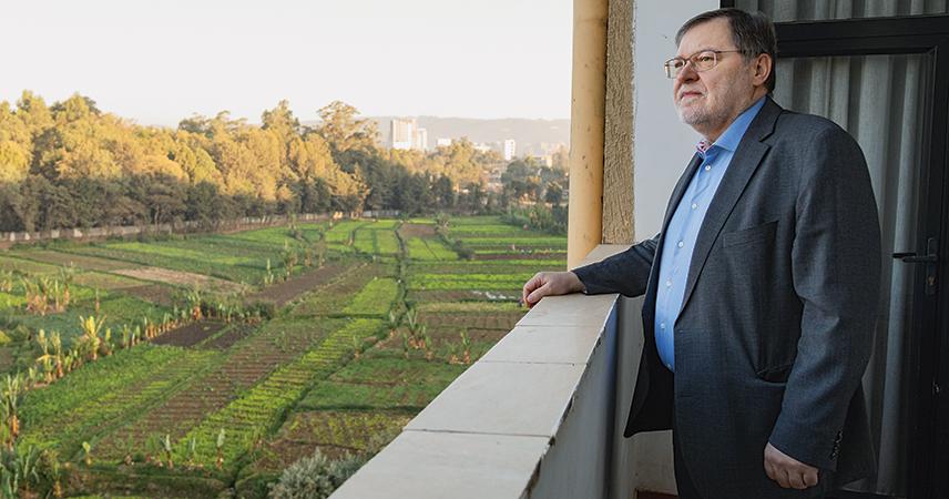 Peter Palesch looks at the fields and trees that line the course of a small river.