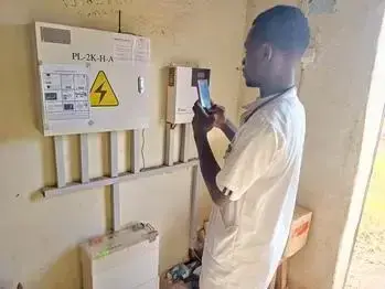 A medical professional performing maintenance work on a piece of equipment.
