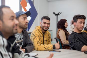 Young people sitting together at an information event on entrepreneurship.