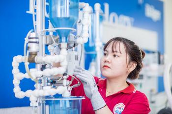 A woman works on water treatment equipment.