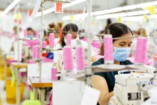 Women work at sewing machines for a clothing company in Cambodia. Copyright: GIZ/Roman Koenig