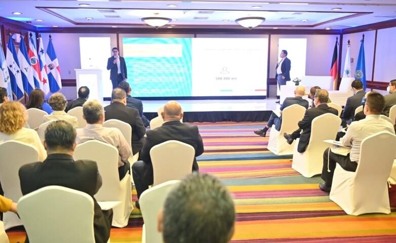 Two advisers on stage presenting the results of the project