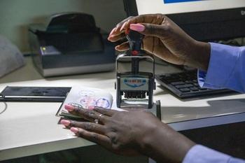 A passport is being stamped.