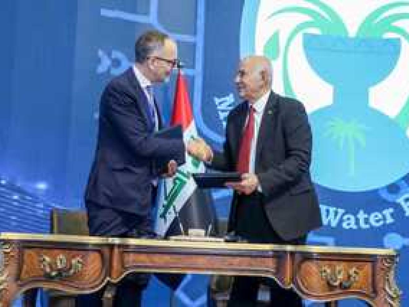 Two men shaking hands over an signed agreement