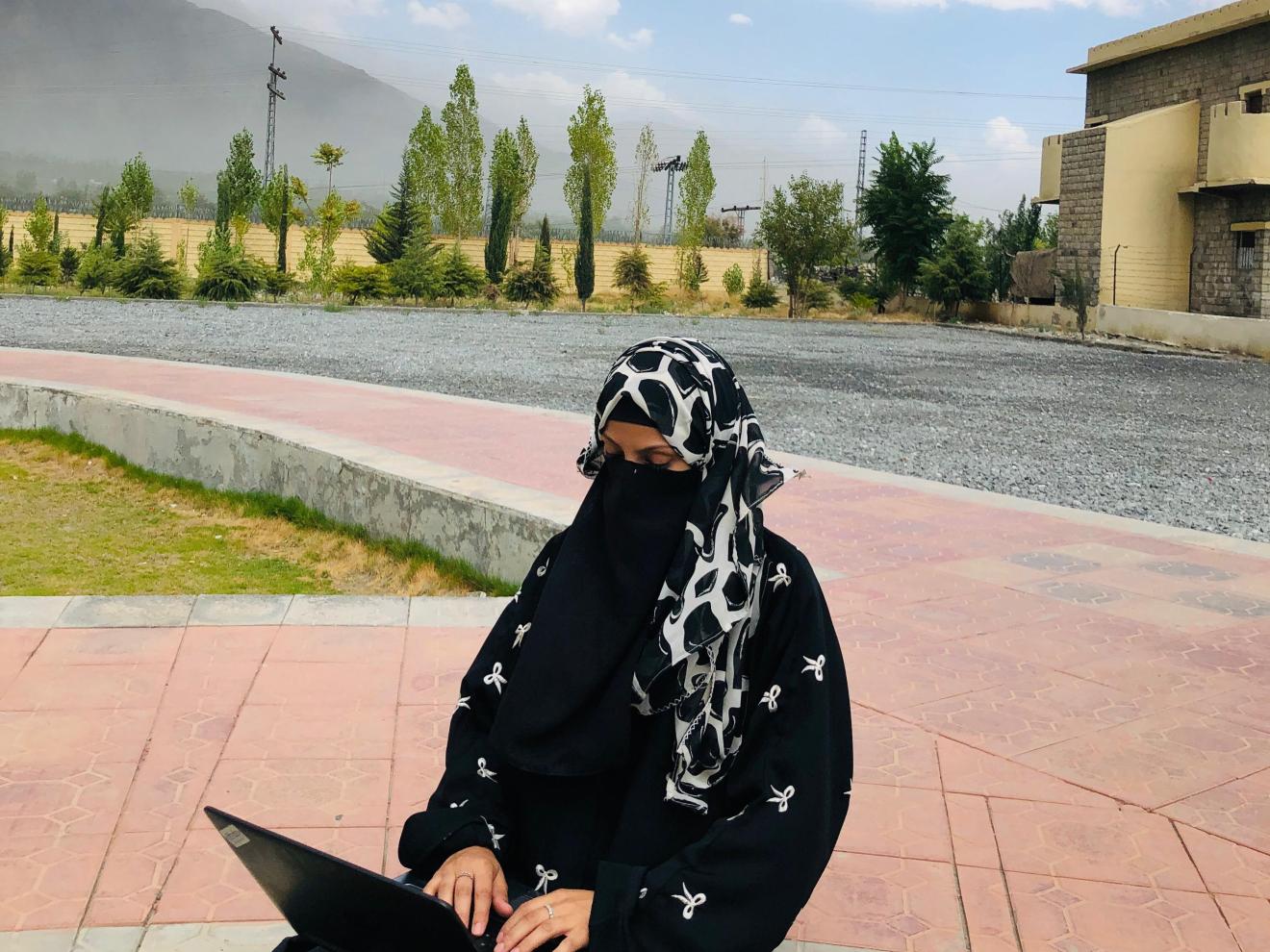 Nausheen is working on her laptop.