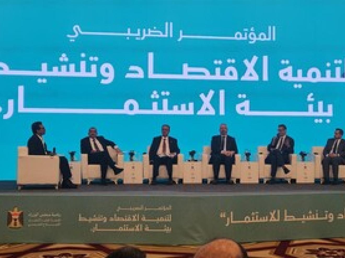 People sitting next to each other on a stage.