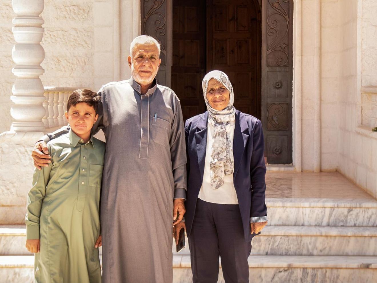 Aida Al Khattab with her husband and grandson