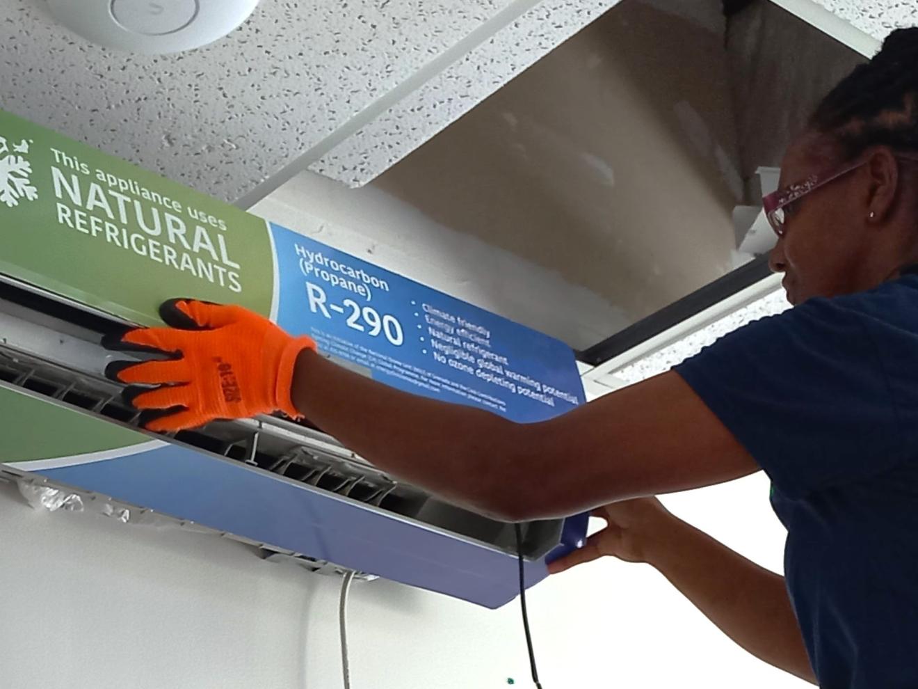 A woman installs an air conditioning system