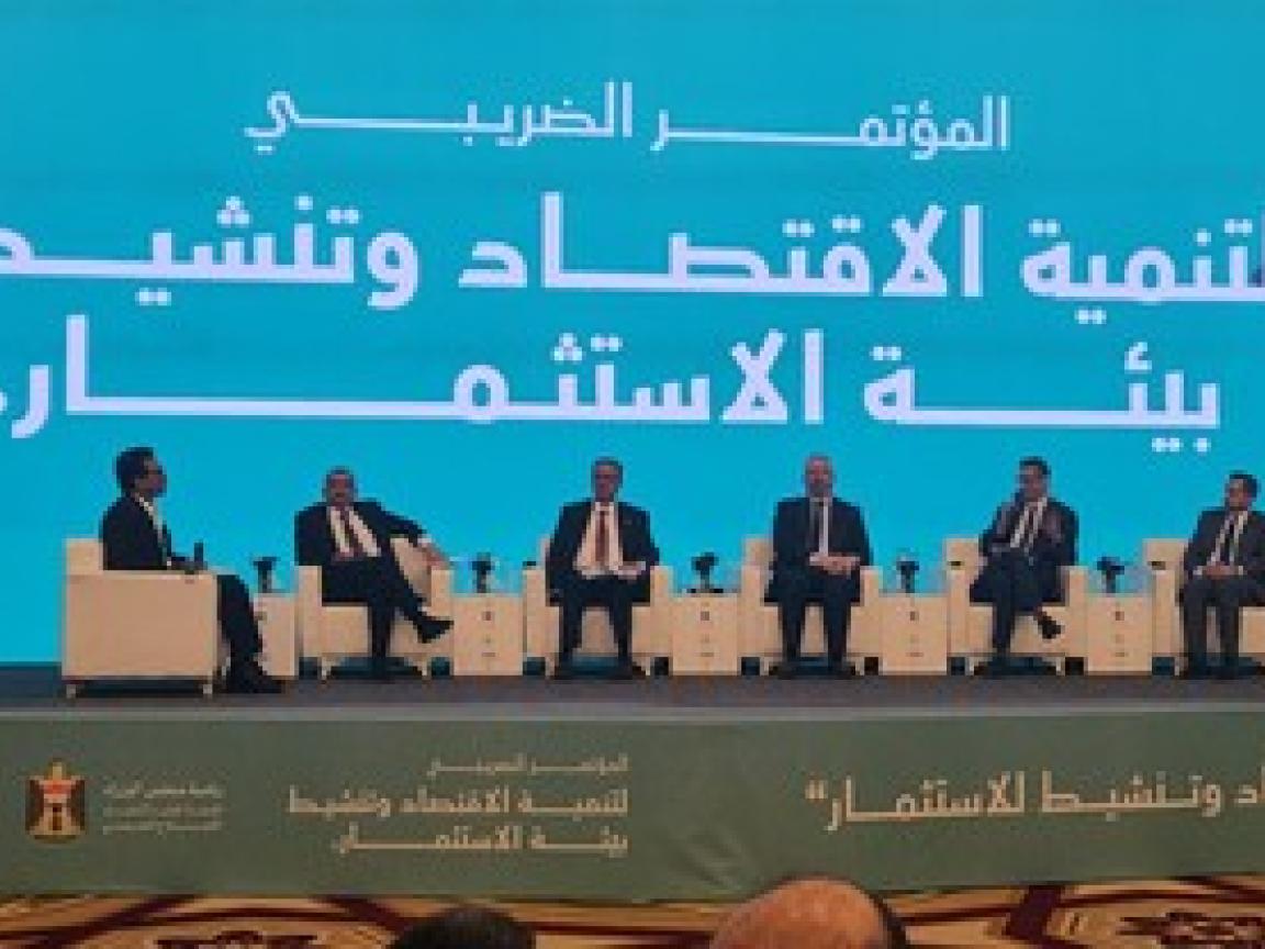 People sitting next to each other on a stage.