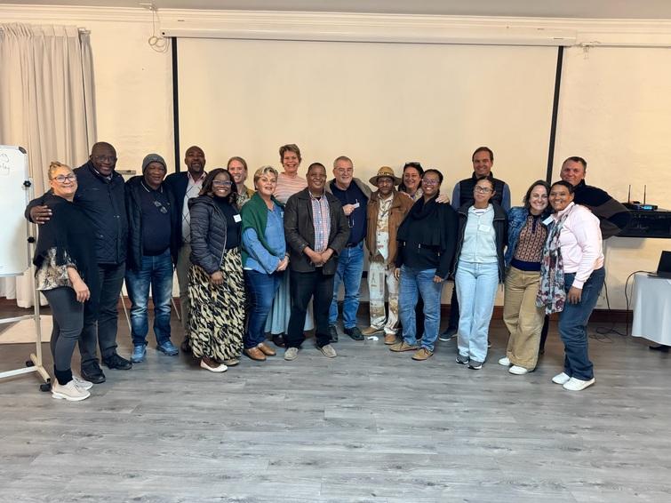 Group photo of 18 people smiling