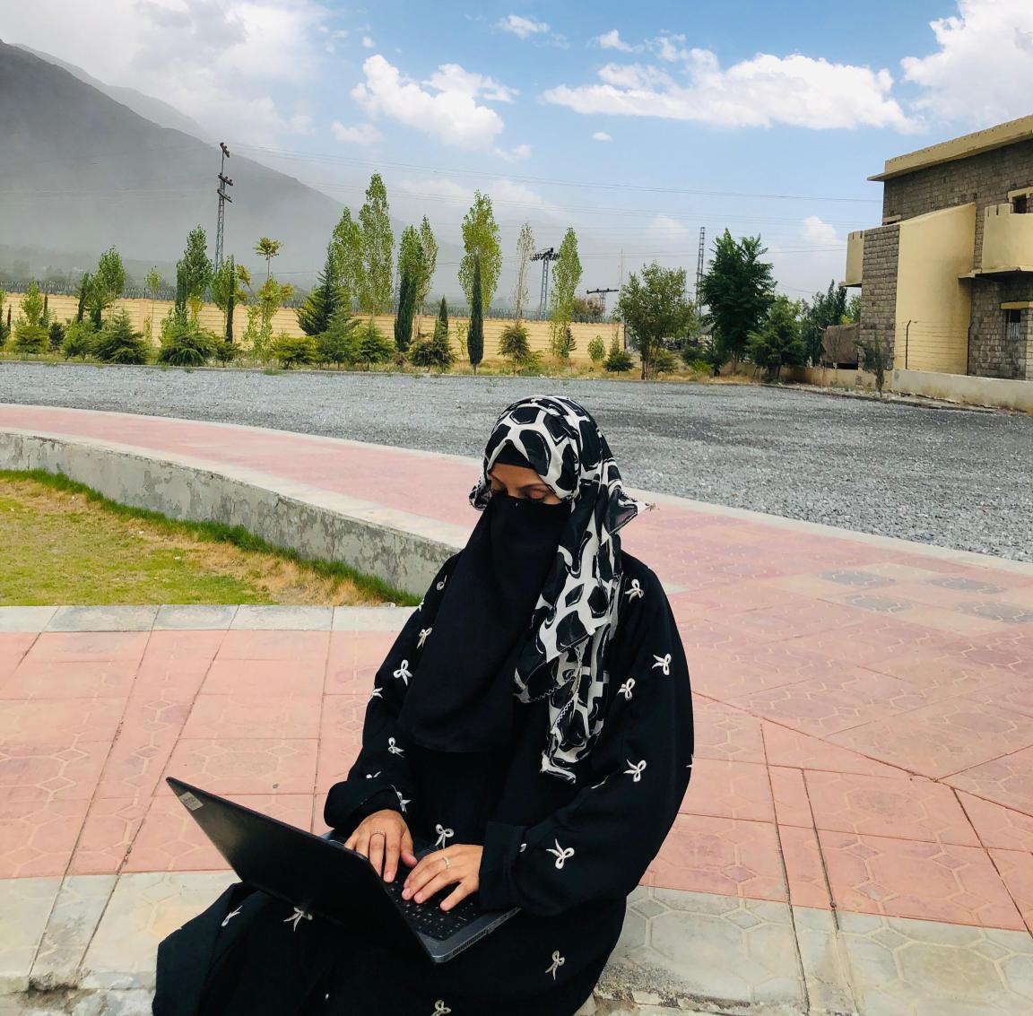 Nausheen is working on her laptop.