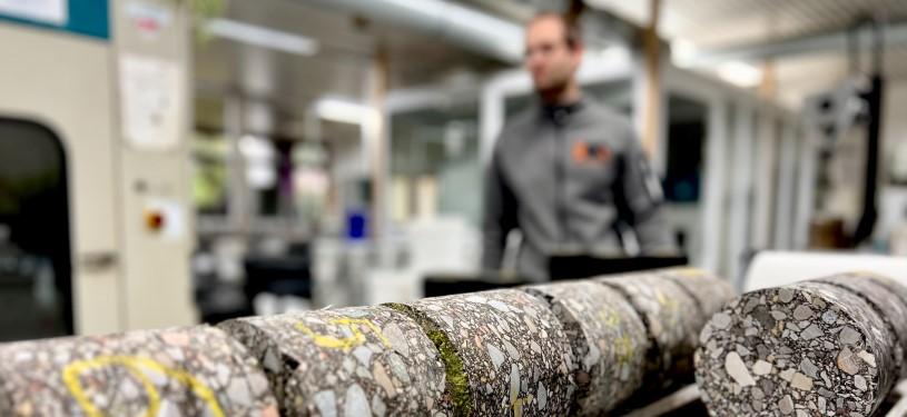 Sustainable aggregate in cross section; in the background, a factory interior.