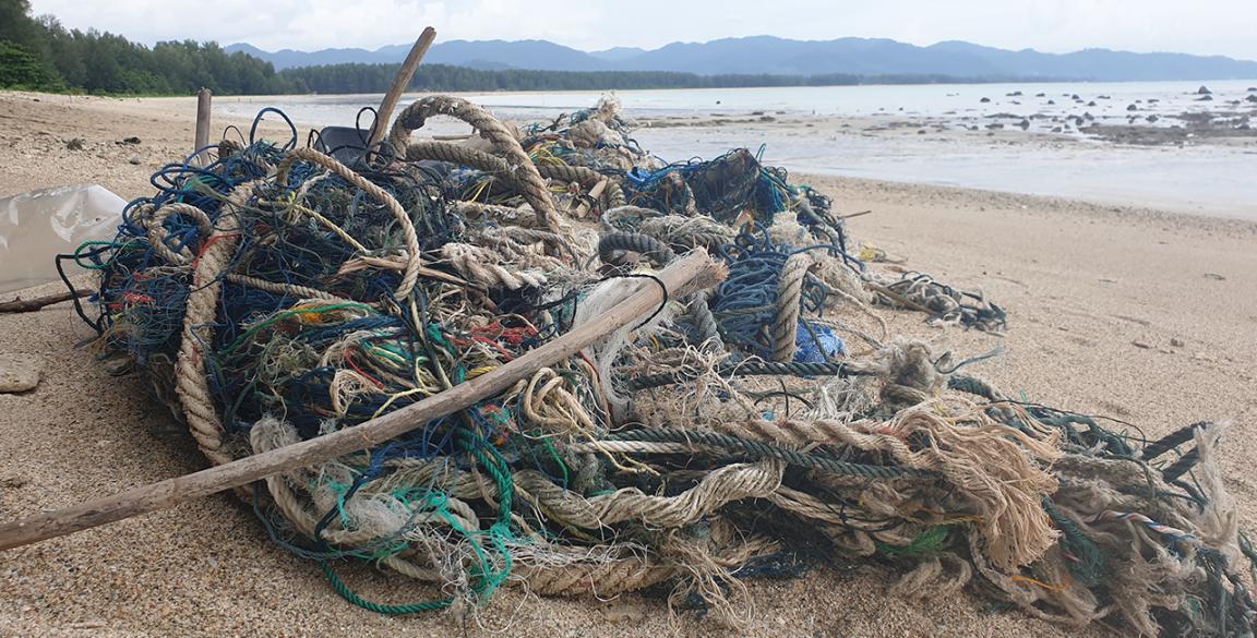 Ship waste consisting of old ropes and nets pollutes a beach
