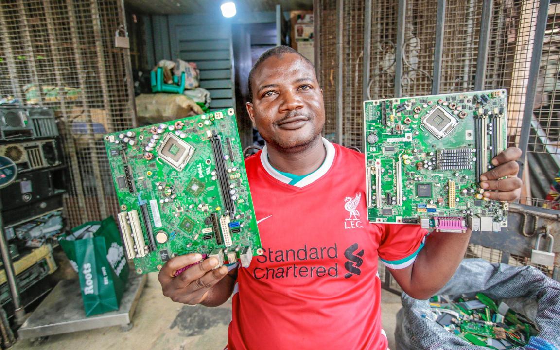 Man holding two circuit boards in his hand