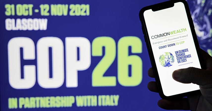 On the left-hand side, you can see a smartphone with the COP26 logo in Glasgow. In the background, slightly blurred, you can see the lettering ‘COP26’ as well as the date ‘31 OCT - 12 NOV 2021’ and the addition ‘in Partnership with Italy’.