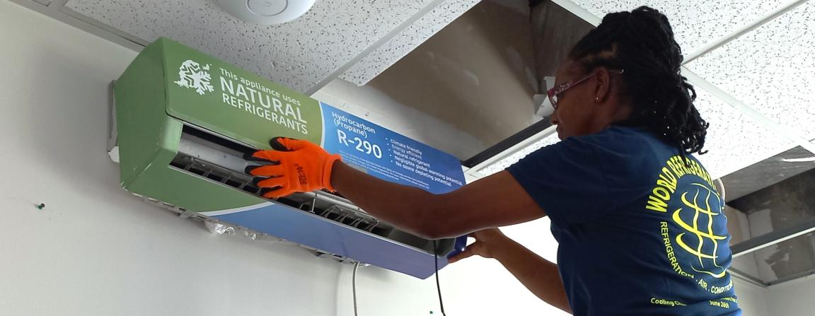 A woman installs an air conditioning system