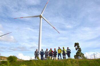 A group of technicians standing in front of a Bolivian wind turbine