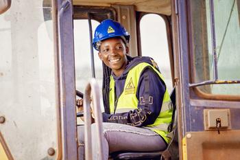 A trainee in Kenya sits in a construction vehicle.