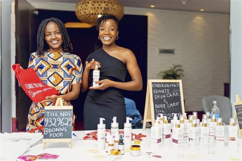 Two young women entrepreneurs presenting their skin care products at their stand.