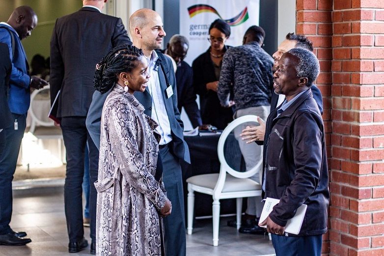 Representatives from Germany and Namibia converse at an event.