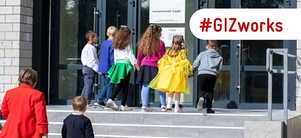 Children enter a reconstructed school in Ukraine. 