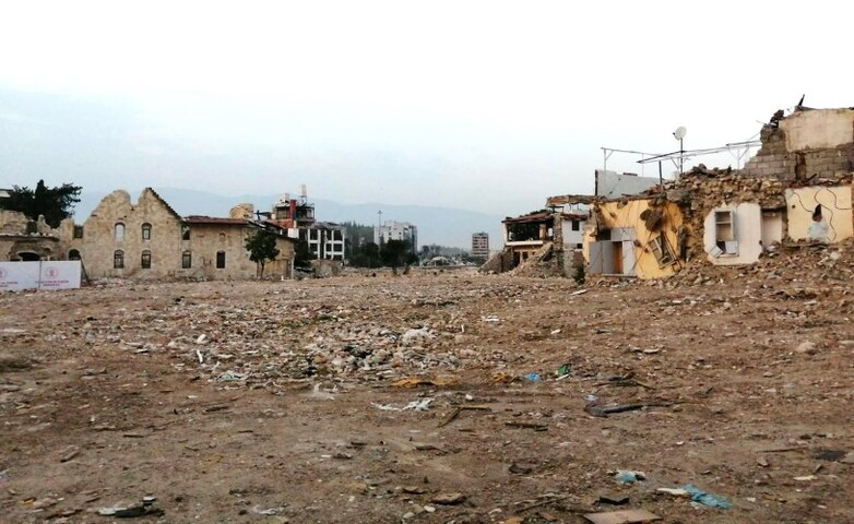 A city street is covered with rubble and debris.