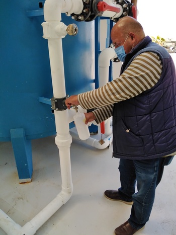 A man draws drinking water from a brackish water treatment plant in Jordan. 