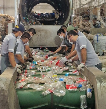 Workers in the recycling industry separating waste.