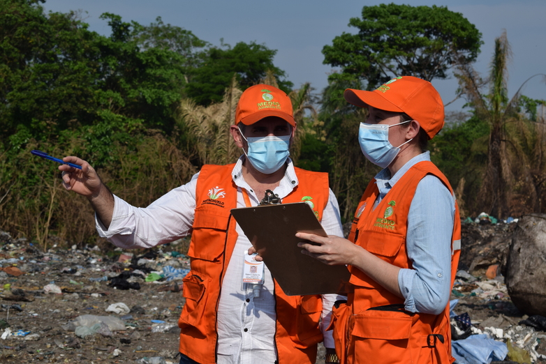 Two environment agency employees on a waste dump.