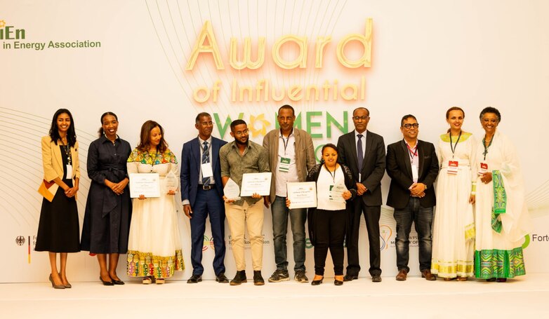 People standing together on a stage at an award ceremony.