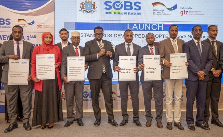 Officials holding placards during the launch of 80 high-quality standards for fruits and vegetables at the National Quality Infrastructure Conference in Mogadishu, Somalia.