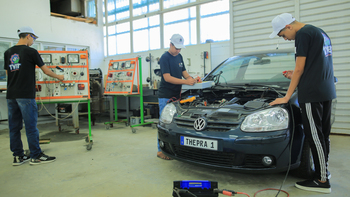 Trainees working in a vehicle repair shop.