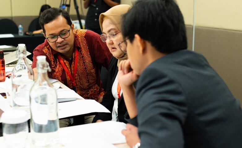 Participants in a climate negotiation training discuss strategies.