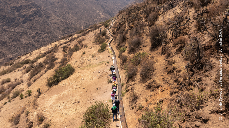 People walk along the water canals.