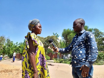 Djafari Byadunia, a journalist at Radio Rurale de Sange, interviewing a woman.