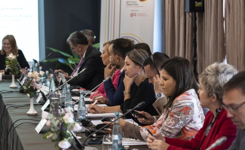 Participants seated at a conference table during a regional cooperation meeting in the Western Balkans, discussing EU integration strategies.