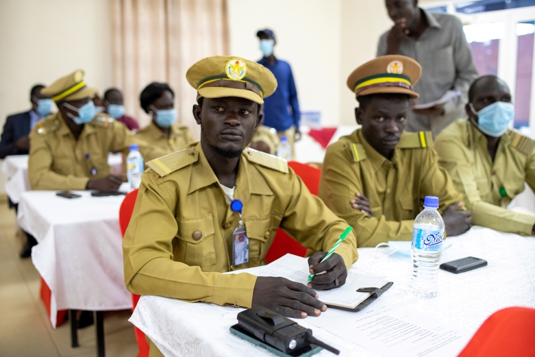 Administrative employees sit in an event room in their uniforms. Copyright: GIZ/Bebe Hillary Joel