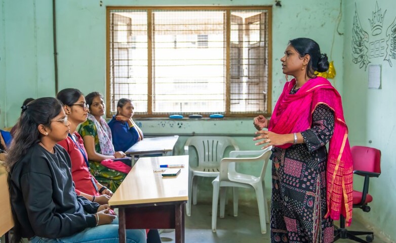 An instructor engages a classroom of attentive students during a technical training session.