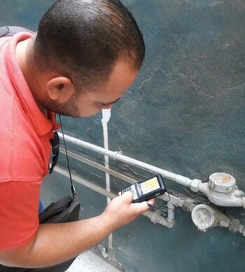 A man is repairing a water faucet.