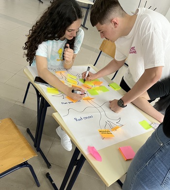 Two young people create a poster together. 