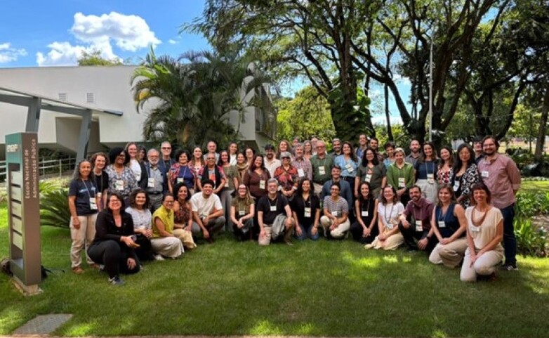 Group photo from a workshop focused on developing Brazil's National Climate Adaptation Plan for the Ocean and Coastal Zone, with participants gathered outdoors.