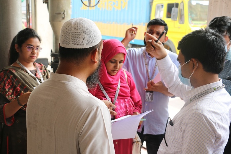 Several people carrying out an inspection and discussing a checklist.