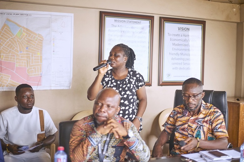 A woman speaking at a district-level gathering.